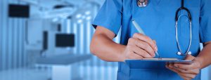 A doctor writing notes on a clipboard-Absolute Surgical Specialist